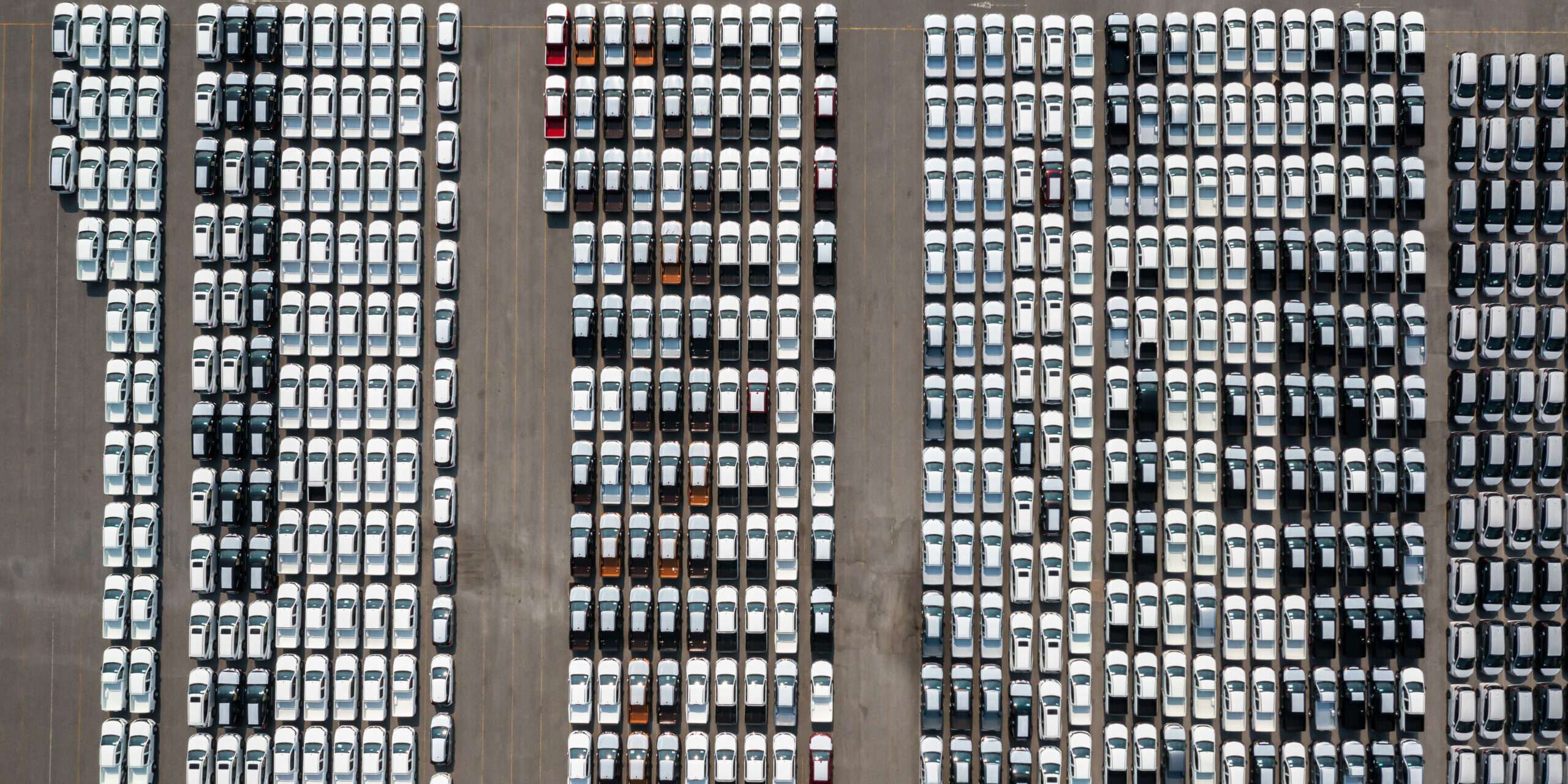 Aerial top view parked new cars at the automotive plant, new car